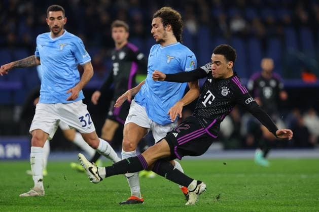 UEFA CHAMPIONS LEAGUE 2023-2024 - Round 16 - SS Lazio vs Bayern Munchen, Olympic Stadium in Rome Rome, Italy 14.2.2024: Guendouzi of Lazio , Jamal Musiala of Bayern Munchen in action during the Uefa Champions League 2023-2024, round of 16 football match SS Lazio vs FC Bayern Mucnhen at Olympic Stadium in Rome. Rome Olympic italy italy Copyright: xmarcoxiacobucci