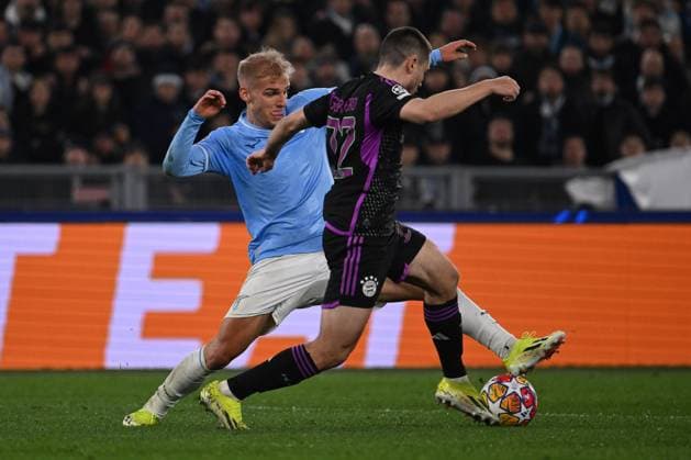 SS Lazio v FC Bayern Munchen: Round of 16 First Leg - UEFA Champions League 2023 24 Gustav Isaksen of S.S. Lazio and Raphael Guerreiro of F.C. Bayern Munchen are competing during the round of 16 of the UEFA Champions League between S.S. Lazio and F.C. Bayern Munich at the Olympic Stadium in Rome, Italy, on February 14, 2024. Rome Italy  Copyright: xDomenicoxCippitellix originalFilename:cippitelli-sslaziov240214_npnAQ.jpg