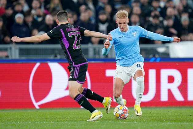 Gustav Isaksen of SS Lazio competes for the ball with Raphael Guerreiro of FC Bayern Munchen during the Uefa Champions League match between SS Lazio and FC Bayern Munchen at Stadio Olimpico Rome Italy on 14 February 2024. Rome Stadio Olimpico Rome Italy Copyright: xPhotoxSportxPicsx SP24-849-027