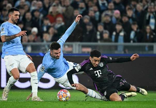 FOOTBALL CHAMPIONS LEAGUE SEASON 2023 2024 Round of 16 first leg 14 02 2024 Lazio Rome FC Bayern Munich Jamal Musiala right, FC Bayern Munich v Mario Gila center, Lazio Rome and Danilo Cataldi left, Lazio Rome