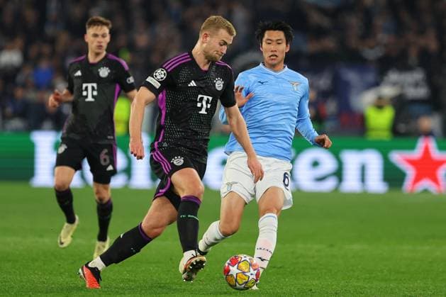 UEFA Champions League football match - SS Lazio vs Bayern Munich Rome, Italy 14.2.2024: Matthijs De Ligt of Bayern fight for the ball with Daichi Kamada of Lazio during the Uefa Champions League 2023-2024, round of 16 football match SS Lazio vs FC Bayern Mucnhen at Olympic Stadium in Rome. Rome Italy  Copyright: xIPAxSport ABACAx