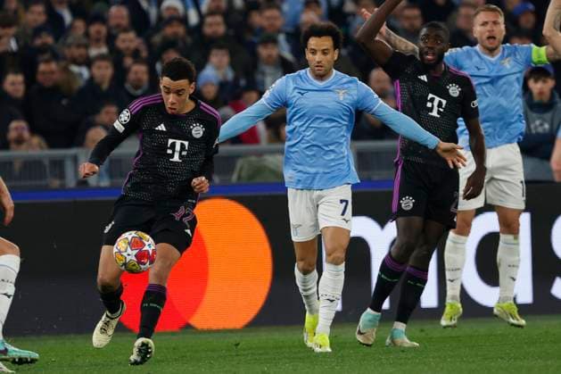 14th February 2024, Stadio Olimpico, Rome, Italy; Champions League Football, Round of 16, First Leg; Lazio versus Bayern Munich; Jamal Musiala of Bayern drives past Felipe Anderson of Lazio  ActionPlus12608994 NaFoto