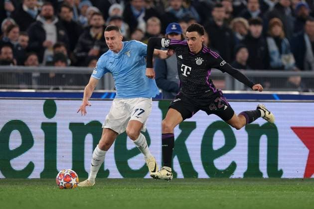 Rome, Italy, 14th February 2024. Jamal Musiala of Bayern München clashes with Adam Marusic of SS Lazio during the UEFA Champions League match at Olimpico, Rome. Picture credit should read: Jonathan Moscrop Sportimage EDITORIAL USE ONLY. No use with unauthorised audio, video, data, fixture lists, club league logos or live services. Online in-match use limited to 120 images, no video emulation. No use in betting, games or single club league player publications. SPI-2933-0069
