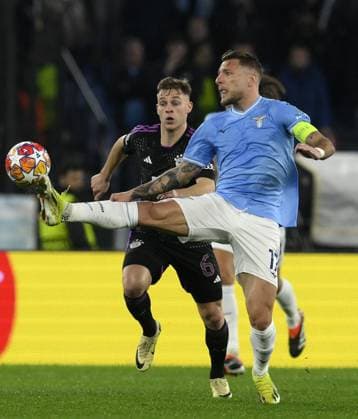 (240215) -- ROME, Feb. 15, 2024 -- Bayern Munich s Joshua Kimmich (L) vies with Lazio s Ciro Immobile during the UEFA Champions League Round of 16 1st Leg match between Lazio and Bayern Munich in Rome, Italy, Feb.14, 2024. (Photo by Xinhua) (SP)ITALY-ROME-FOOTBALL-UEFA CHAMPIONS LEAGUE-ROUND OF 16-LAZIO VS BAYERN MUNICH AugustoxCasasoli 
