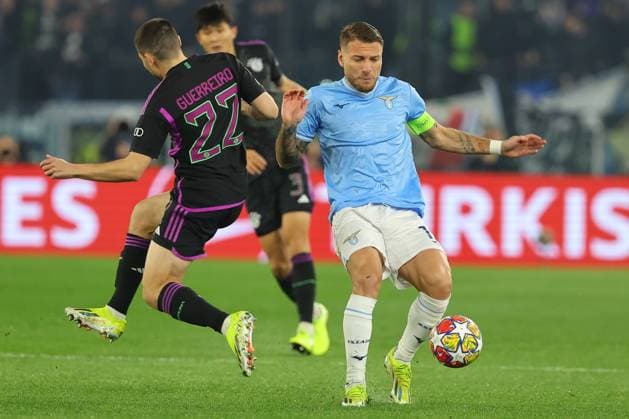 Rome, Italy 14.2.2024: Raphael Guerreiro of Bayern Munchen fight for the ball with Ciro Immobile of Lazio during the Uefa Champions League 2023-2024, round of 16 football match SS Lazio vs FC Bayern Mucnhen at Olympic Stadium in Rome.  Copyright: xMarcoxIacobucci IPAxSportx xipa-x xx IPA_43441364 IPA_Agency_IPA43441364