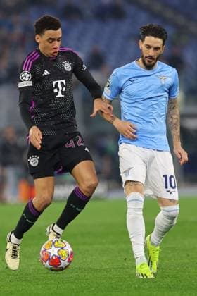 Rome, Italy 14.2.2024: Raphael Guerreiro of Bayern Munchen fight for the ball with Ciro Immobile of Lazio during the Uefa Champions League 2023-2024, round of 16 football match SS Lazio vs FC Bayern Mucnhen at Olympic Stadium in Rome.  Copyright: xMarcoxIacobucci IPAxSportx xipa-x xx IPA_43441469 IPA_Agency_IPA43441469