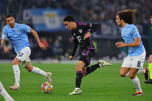 Rome, Italy 14.2.2024: Jamal Musiala of Bayern Munchen, Guendouzi of Lazio in action during the Uefa Champions League 2023-2024, round of 16 football match SS Lazio vs FC Bayern Mucnhen at Olympic Stadium in Rome.  Copyright: xMarcoxIacobucci IPAxSportx xipa-x xx IPA_43441487 IPA_Agency_IPA43441487
