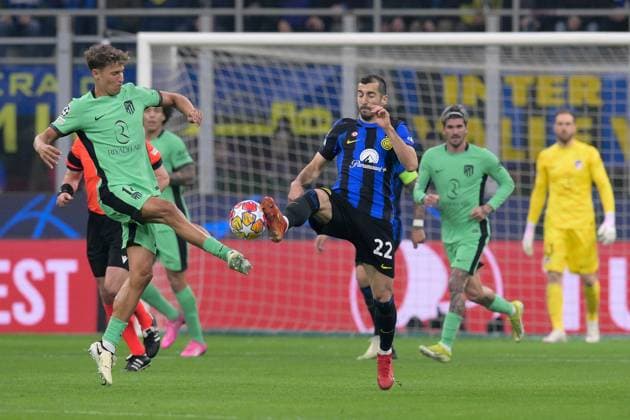 20th February 2024; Stadio San Siro, Milan, Italy, Champions League Football, Round of 16, First Leg, Inter Milan versus Atletico Madrid; Marcos Llorente and Henrikh Mkhitaryan of FC Internazionale Milan challenge for possession of the loose ball  ActionPlus12610777 AllShotLive