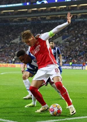 Porto, Portugal, 21st February 2024. Martin Odegaard of Arsenal hold off Wendell of FC Porto during the UEFA Champions League match at the Estadio do Dragao, Porto. Picture credit should read: David Klein Sportimage EDITORIAL USE ONLY. No use with unauthorised audio, video, data, fixture lists, club league logos or live services. Online in-match use limited to 120 images, no video emulation. No use in betting, games or single club league player publications. SPI-2957-0034