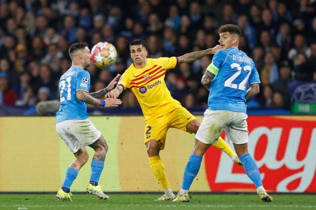 Matteo Politano (SSC Napoli) and Joao Cancelo FC Barcelona, Barca battle for the ball, UEFA Champions League 2023 2024 - Round of 16 First Leg, SSC Napoli vs FC Barcelona, Diego Armando Maradona StadiuÃ¬, February 21, 2024, Naples, Italy.