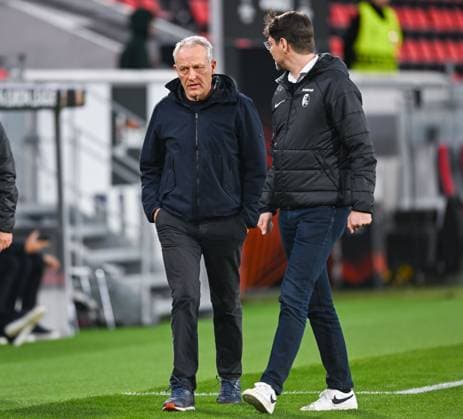 Germany, Freiburg, 22 02 2024, Europa Park Stadion, SC Freiburg vs RC Lens UEFA Europa League, Trainer Christian Streich SC Freiburg walks with Pressesprecher Sascha Glunk SC Freiburg to an interview Freiburg Europa Park Stadion Baden Wuerttemberg Germany eu-images-738