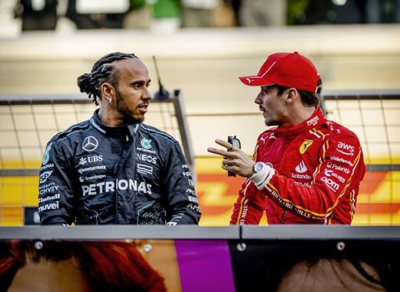 BAHRAIN - Lewis Hamilton (Mercedes) and Charles Leclerc (Ferrari) on the grid ahead of the Bahrain Grand Prix. ANP REMKO DE WAAL Race 2024 2025 xVIxANPxSportx xxANPxIVx 492603299 originalFilename: 492603299.jpg