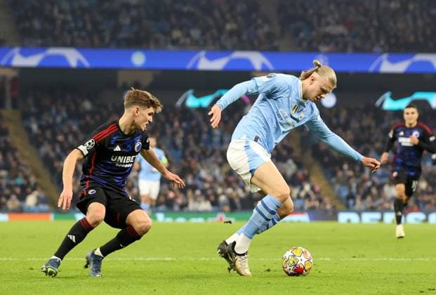 6th March 2024; Etihad Stadium, Manchester, England; Champions League Football, Round of 16, Manchester City versus Copenhagen; Erling Haaland of Manchester City beats Elias Jelert of FC Copenhagen to shoot and score his sides& x2019; third goal for 3-1 after 3 minutes of added time in the first half  ActionPlus12615759 DavidxBlunsden