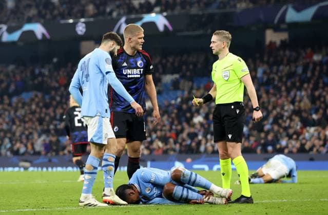 6th March 2024; Etihad Stadium, Manchester, England; Champions League Football, Round of 16, Manchester City versus Copenhagen; Andreas Cornelius of FC Copenhagen is shown a yellow card for his foul on Manuel Akanji of Manchester City  ActionPlus12615830 DavidxBlunsden