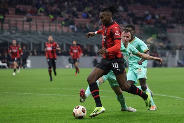 Milan, Italy, 7th March 2024. Rafael Leao of AC Milan takes on Tomas Vlcek and Murphy Dorley of Slavia Praha as he breaks into the area to zset up team mate Christian Pulisic to give the sdie a 4-2 lead during the UEFA Europa League match at Giuseppe Meazza, Milan. Picture credit should read: Jonathan Moscrop Sportimage EDITORIAL USE ONLY. No use with unauthorised audio, video, data, fixture lists, club league logos or live services. Online in-match use limited to 120 images, no video emulation. No use in betting, games or single club league player publications. SPI-2971-0070