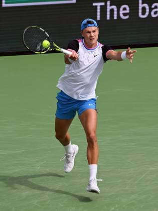 INDIAN WELLS, CA - MARCH 11: Holger Rune (DEN) returns the ball during an ATP, Tennis Herren tennis match played on March 11, 2024 during the BNP Paribas Open played at the Indian Wells Tennis Garden in Indian Wells, CA. (Photo by John Cordes Icon Sportswire) TENNIS: MAR 11 BNP Paribas Open EDITORIAL USE ONLY Icon506240311007
