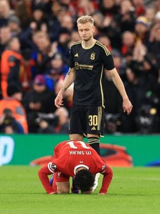 Liverpool FC v AC Sparta Prague Mohamed Salah of Liverpool (11) scores his sides third goal of the match and kisses the pitch as Jaroslav Zeleny of Sparta Prague looks on during the Liverpool FC v AC Sparta Prague Last 16, 2nd Leg UEFA Europa League match at Anfield, Liverpool, England, United Kingdom on 14 March 2024 Editorial use only. All images are copyright Every Second Media Limited. No images may be reproduced without prior permission. Copyright: xIMAGO EveryxSecondxMediax ESM-0951-0041