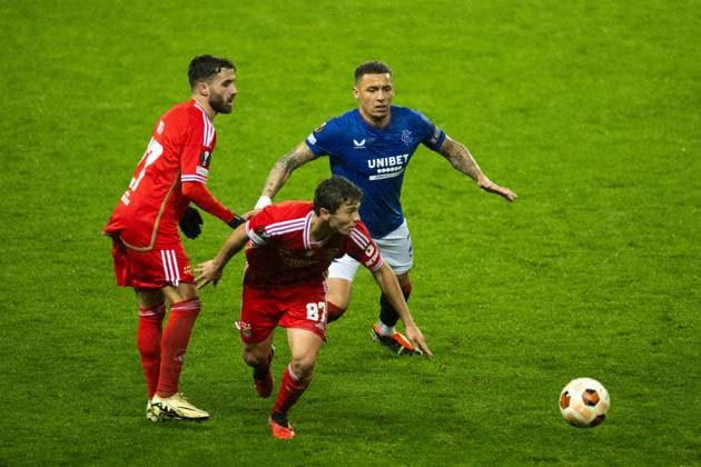 Rangers captain James Tavernier and Joao Neves of Benfica during the Europa League match at Ibrox Stadium, Glasgow. Rangers v Benfica, UEFA Europa League, Round of 16, Second Leg, Football, Ibrox Stadium, Glasgow, UK - 14 Mar 2024 EDITORIAL USE ONLY No use with unauthorised audio, video, data, fixture lists, club league logos or live services. Online in-match use limited to 120 images, no video emulation. No use in betting, games or single club league player publications. Copyright: xKirkxO Rourke RangersxFC Shutterstockx 14389044br