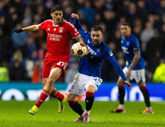 Rangers Midfielder Nicolas Raskin in action with Tiago Gouveia of Benfica during UEFA Europa League Round of 16 Second Leg match at Ibrox. Rangers v Benfica, UEFA Europa League, Round of 16, Second Leg, Football, Ibrox Stadium, Glasgow, UK - 14 Mar 2024 EDITORIAL USE ONLY No use with unauthorised audio, video, data, fixture lists, club league logos or live services. Online in-match use limited to 120 images, no video emulation. No use in betting, games or single club league player publications. Copyright: xLukexNickerson RangersxFC Shutterstockx 14389051bl