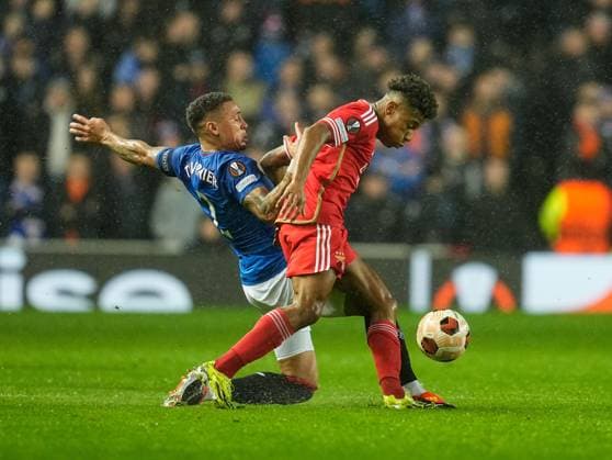 Rangers Captain James Tavernier tackles David Neres of Benfica. Rangers v Benfica, UEFA Europa League, Round of 16, Second Leg, Football, Ibrox Stadium, Glasgow, UK - 14 Mar 2024 EDITORIAL USE ONLY No use with unauthorised audio, video, data, fixture lists, club league logos or live services. Online in-match use limited to 120 images, no video emulation. No use in betting, games or single club league player publications. Copyright: xStuartxWallace Shutterstockx 14385550aj