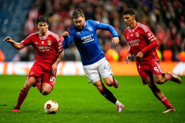 Nicolas Raskin of Rangers runs between Joao Neves & Alexander Bah of Benfica. Rangers v Benfica, UEFA Europa League, Round of 16, Second Leg, Football, Ibrox Stadium, Glasgow, UK - 14 Mar 2024 EDITORIAL USE ONLY No use with unauthorised audio, video, data, fixture lists, club league logos or live services. Online in-match use limited to 120 images, no video emulation. No use in betting, games or single club league player publications. Copyright: xStuartxWallace Shutterstockx 14385550bv