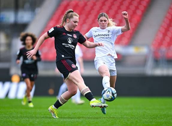 Germany, Nuremberg, 17 03 2024, Max Morlock Stadion, 1 FC Nuremberg vs SC Freiburg Frauen Bundesliga, Madeleine Steck 1 FC Nuremberg and Eileen Campbell SC Freiburg battle for the ball Nuremberg Max Morlock Stadion Bavaria Germany eu-images-738