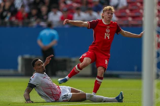 March 23, 2024, Frisco, Texas, USA: Canada s JACOB SHAFFELBURG (14) watches the ball enter the Trinidad and Tobago net and scores Canada s second goal as Trinidad and Tobago s ALVIN JONES (16) stretches out in a defensive move during their Concacaf Nations League match on Saturday at Toyota Stadium. Frisco USA - ZUMAm257 20240323_zsp_m257_013 Copyright: xBrianxMcLeanx