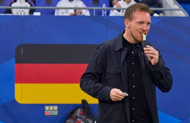 DFB headcoach Julian Nagelsmann , Bundestrainer, Nationaltrainer, with chewing gum in front of the german national flag in the friendly match FRANCE - GERMANY 0-2 FRANKREICH - DEUTSCHLAND 0-2 in preparation for European Championships 2024 on Mar 23, 2024 in Lyon, France.