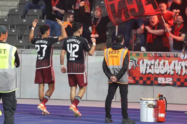 DEU, DFL, 2 FBL, Hertha BSC vs 1 FC Nuernberg, 30 03 2024, Berliner Olympiastadion, Berlin, DEU, DFL, 2 FBL, Hertha BSC vs 1 FC Nuernberg, im Bild 3 1 durch Can Yilmaz Uzun 1 FC Nuernberg 42 , Nathaniel Brown 1 FC Nuernberg 27 , Nuernberger Fans DFL regulations prohibit any use of Photographs as image sequences and or quasi video Foto Juergen Engler nordphoto GmbH nordphotoxGmbHx xEngler nph00076