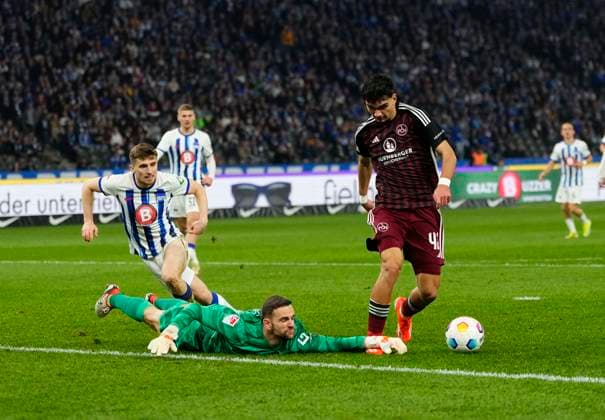Germany, Berlin, 30 03 2024, Olympic Stadium, Hertha BSC vs 1 FC Nürnberg 2 Bundesliga, Marius Gersbeck Hertha Berlin and Can Uzun 1 FC Nürnberg battle for the ball Berlin Olympic Stadium Berlin Germany eu-images-659