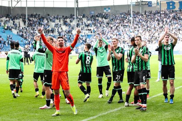 Goalkeeper Ron Robert Zieler Hannover 96,1 , Marcel Halstenberg Hannover 96,23 , Fabian Kunze Hannover 96,6 celebrate with the Hannover 96 team after the match in front of the fan block 2 Soccer Bundesliga Season 2023 2024 1 FC Magdeburg vs Hannover 96 at the MDCC Arena in Magdeburg Action,Soccer,Man,Men,Germany,31 03 2024