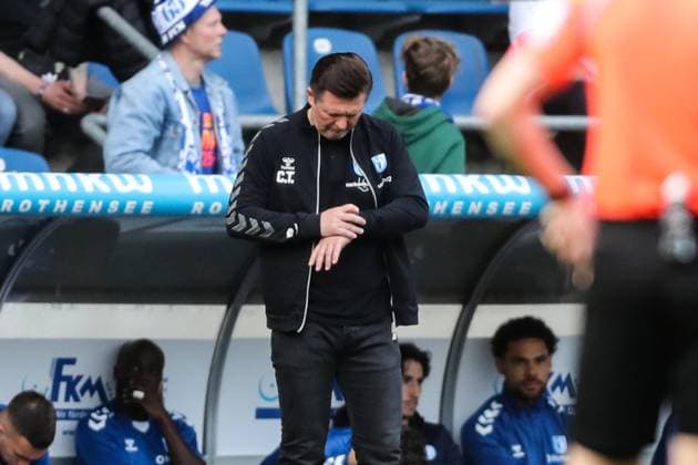 Coach Christian Titz 1 FC Magdeburg looks at the clock 2 Soccer Bundesliga Season 2023 2024 1 FC Magdeburg vs Hannover 96 at the MDCC Arena in Magdeburg Soccer,Man,Men,Germany,31 03 2024