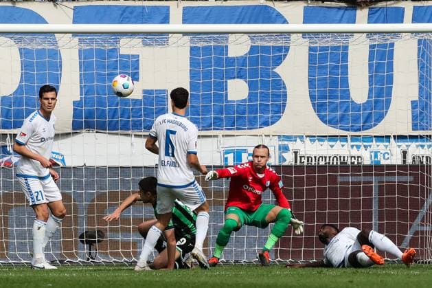 from l Tobias Müller 1 FC Magdeburg,21 , Daniel Elfadli 1 FC Magdeburg,6 , Nicolo Tresoldi Hannover 96,9 , Goalkeeper Dominik Reimann 1 FC Magdeburg,1 , Daniel Heber 1 FC Magdeburg,15 2 Soccer Bundesliga Season 2023 2024 1 FC Magdeburg vs Hannover 96 at the MDCC Arena in Magdeburg Action,Soccer,Man,Men,Germany,31 03 2024