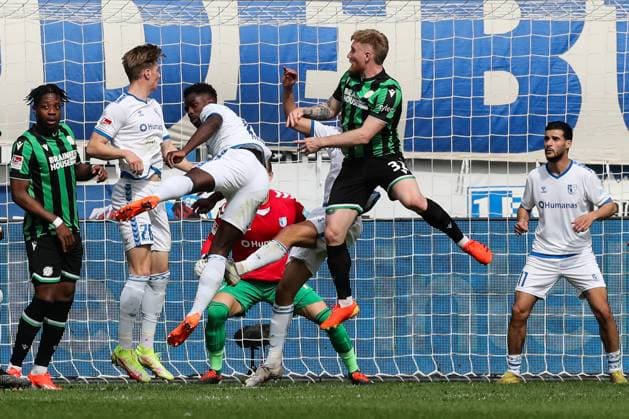 Andreas Voglsammer Hannover 96,32 and Bright Arrey Mbi Hannover 96,4 against v r Luca Schuler 1 FC Magdeburg,26 , Daniel Heber 1 FC Magdeburg,15 , Mohammed El Hankouri 1 FC Magdeburg,11 2 Soccer Bundesliga Season 2023 2024 1 FC Magdeburg vs Hannover 96 at the MDCC Arena in Magdeburg Action,Soccer,Man,Men,Germany,31 03 2024
