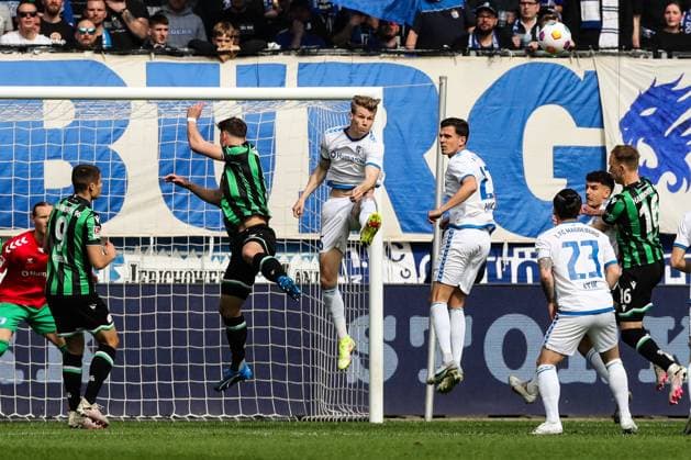 Luca Schuler 1 FC Magdeburg,26 and Tobias Müller 1 FC Magdeburg,21 against Phil Neumann Hannover 96,5 2 Soccer Bundesliga Season 2023 2024 1 FC Magdeburg vs Hannover 96 at the MDCC Arena in Magdeburg Action,Soccer,Man,Men,Germany,31 03 2024