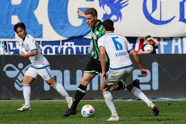 Marcel Halstenberg Hannover 96,23 vs Tatsuya Ito 1 FC Magdeburg,37 and Daniel Elfadli 1 FC Magdeburg,6 2 Soccer Bundesliga Season 2023 2024 1 FC Magdeburg vs Hannover 96 at the MDCC Arena in Magdeburg Action,Soccer,Man,Men,Germany,31 03 2024