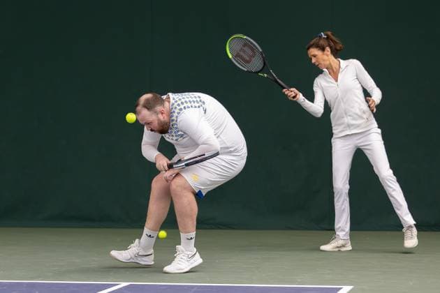 AFC Wimbledon Wimbledon Tennis Training Session AFC Wimbledon Head of Football Operations Craig Cope plays tennis with Annabelle Croft during an AFC Wimbledon team visit to The All England Lawn Tennis and Croquet Club, Wimbledon, United Kingdom on 8 April 2024. Editorial use only , Copyright: xIanxStephenx PSI-19409-0089