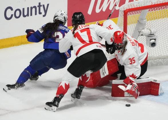 April 8, 2024, Utica, Ny, UNITED STATES: Canada goaltender Ann-Renee Desbiens (35) makes a save against United States Abbey Murphy (37) as Canada s Ella Shelton (17) skates in to defend during first period hockey action at the IIHF Women s World Hockey Championship in Utica, N.Y., Monday, April 8, 2024. Canada News - April 8, 2024  - ZUMAc35_ 20240408_zaf_c35_244 Copyright: xChristinnexMuschix
