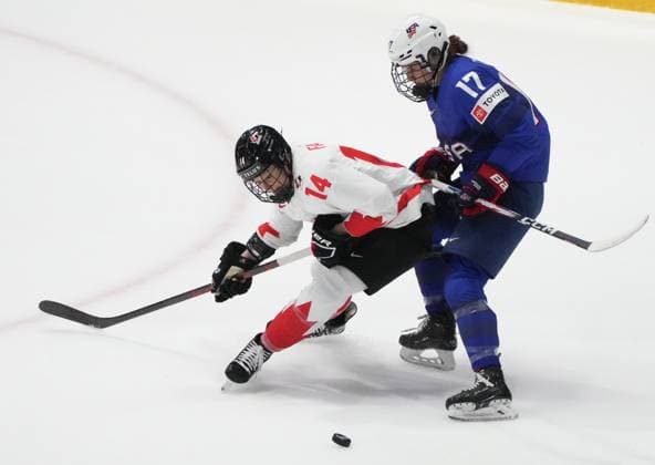 April 8, 2024, Utica, Ny, UNITED STATES: Canada s Renata Fast (14) and United States Britta Curl (17) battle for the puck during first period hockey action at the IIHF Women s World Hockey Championship in Utica, N.Y., Monday, April 8, 2024. Canada News - April 8, 2024  - ZUMAc35_ 20240408_zaf_c35_247 Copyright: xChristinnexMuschix