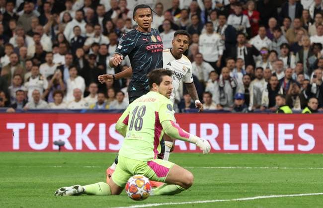 Madrid, Spain, 9th April 2024. Rodrygo of Real Madrid (R) scores their second goal during the UEFA Champions League match at the Santiago Bernabau, Madrid. Picture credit should read: Paul Terry Sportimage EDITORIAL USE ONLY. No use with unauthorised audio, video, data, fixture lists, club league logos or live services. Online in-match use limited to 120 images, no video emulation. No use in betting, games or single club league player publications. SPI-3066-0046