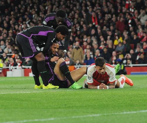 Football - 2023 2024 UEFA Champions League - Quarter-final - First Leg - Arsenal vs Bayern Munich - Emirates Stadium - Tuesday 9th April 2024 Leroy Sane of Bayern Munich is helped to his feet after Ben White of Arsenal fouled him to give away a penalty kick. 