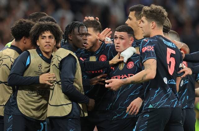 Madrid, Spain, 9th April 2024. Phil Foden of Manchester City (C) celebrates with team mates after scoring his teams second goal during the UEFA Champions League match at the Santiago Bernabau, Madrid. Picture credit should read: Paul Terry Sportimage EDITORIAL USE ONLY. No use with unauthorised audio, video, data, fixture lists, club league logos or live services. Online in-match use limited to 120 images, no video emulation. No use in betting, games or single club league player publications. SPI-3066-0071