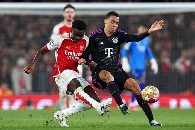 Bukayo Saka of Arsenal (L) battles with Jamal Musiala of Bayern Munich (R) Arsenal v Bayern Munich, UEFA Champions League, Quarter Final, First Leg, Football, Emirates Stadium, London, UK - 09 Apr 2024 EDITORIAL USE ONLY No use with unauthorised audio, video, data, fixture lists, club league logos or live services. Online in-match use limited to 120 images, no video emulation. No use in betting, games or single club league player publications. Copyright: xSimonxDael Shutterstockx 14424047cl