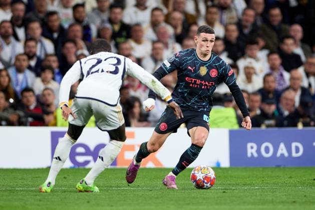 Phil Foden of Manchester City runs with the ball during the UEFA Champions League 2023 24 quarter-finals match between Real Madrid CF and Manchester City at Estadio Santiago Bernabeu on April 09, 2024 in Madrid, Spain. FOOTBALL : Real Madrid vs Manchester City - UEFA Ligue des Champions - 1 4 Quart - 09 04 2024 LGM Panoramic 