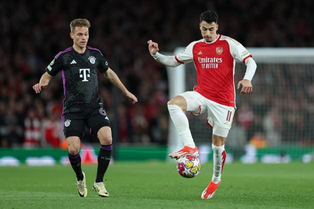 London, England, 9th April 2024. Joshua Kimmich of Bayern Munich (left) and Gabriel Martinelli of Arsenal (right) battle for the ball during the UEFA Champions League match at the Emirates Stadium, London. Picture credit should read: Kieran Cleeves Sportimage EDITORIAL USE ONLY. No use with unauthorised audio, video, data, fixture lists, club league logos or live services. Online in-match use limited to 120 images, no video emulation. No use in betting, games or single club league player publications. SPI-3065-0063