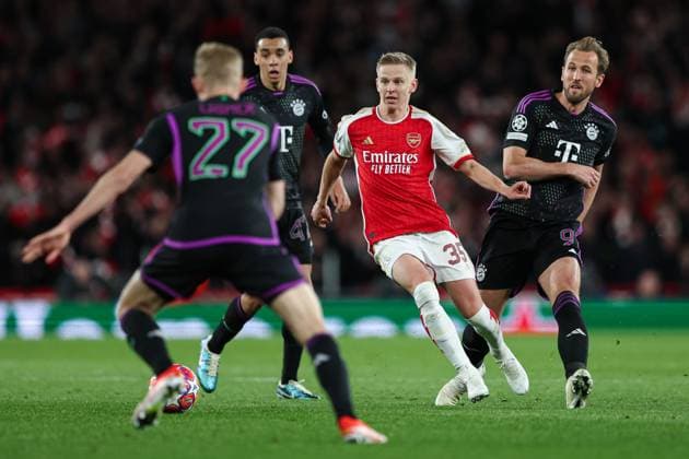 London, England, 9th April 2024. Oleksandr Zinchenko of Arsenal (centre) and Harry Kane of Bayern Munich (right) compete for the ball during the UEFA Champions League match at the Emirates Stadium, London. Picture credit should read: Kieran Cleeves Sportimage EDITORIAL USE ONLY. No use with unauthorised audio, video, data, fixture lists, club league logos or live services. Online in-match use limited to 120 images, no video emulation. No use in betting, games or single club league player publications. SPI-3065-0124
