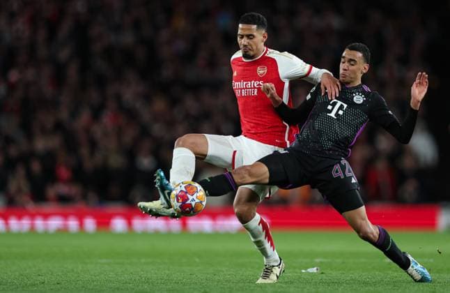 London, England, 9th April 2024. William Saliba of Arsenal (left) and Jamal Musiala of Bayern Munich (right) battle for the ball during the UEFA Champions League match at the Emirates Stadium, London. Picture credit should read: Kieran Cleeves Sportimage EDITORIAL USE ONLY. No use with unauthorised audio, video, data, fixture lists, club league logos or live services. Online in-match use limited to 120 images, no video emulation. No use in betting, games or single club league player publications. SPI-3065-0075