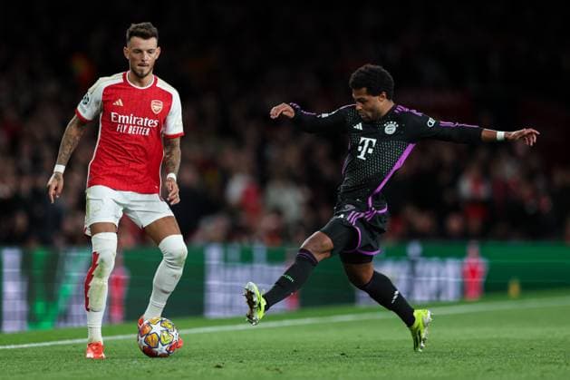 London, England, 9th April 2024. Ben White of Arsenal (left) and Serge Gnabry of Bayern Munich (right) battle for the ball during the UEFA Champions League match at the Emirates Stadium, London. Picture credit should read: Kieran Cleeves Sportimage EDITORIAL USE ONLY. No use with unauthorised audio, video, data, fixture lists, club league logos or live services. Online in-match use limited to 120 images, no video emulation. No use in betting, games or single club league player publications. SPI-3065-0095