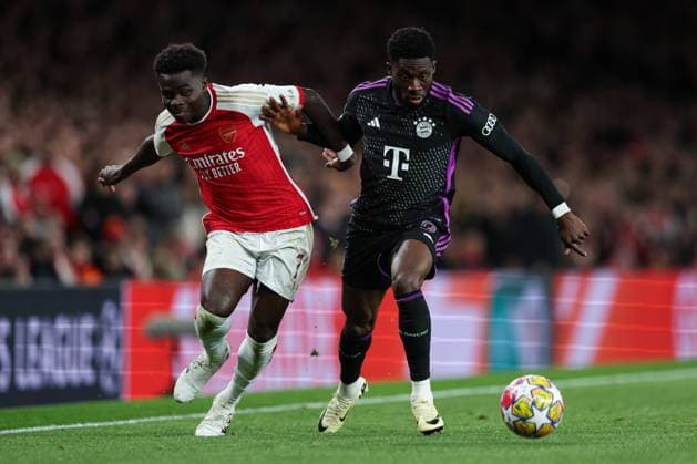 London, England, 9th April 2024. Bukayo Saka of Arsenal (left) and Alphonso Davies of Bayern Munich (right) battle for the ball during the UEFA Champions League match at the Emirates Stadium, London. Picture credit should read: Kieran Cleeves Sportimage EDITORIAL USE ONLY. No use with unauthorised audio, video, data, fixture lists, club league logos or live services. Online in-match use limited to 120 images, no video emulation. No use in betting, games or single club league player publications. SPI-3065-0100