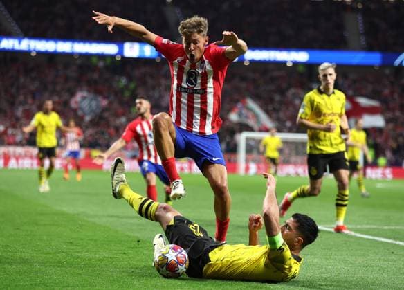 Madrid, Spain, 10th April 2024. Marcos Llorente of Athletico Madrid and Emre Can of Borussia Dortmund challenge for the ball during the UEFA Champions League match at Wanda Metropolitano, Madrid. Picture credit should read: Paul Terry Sportimage EDITORIAL USE ONLY. No use with unauthorised audio, video, data, fixture lists, club league logos or live services. Online in-match use limited to 120 images, no video emulation. No use in betting, games or single club league player publications. SPI-3067-0030